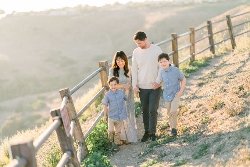 Tim St. John with his family on a hillside trail